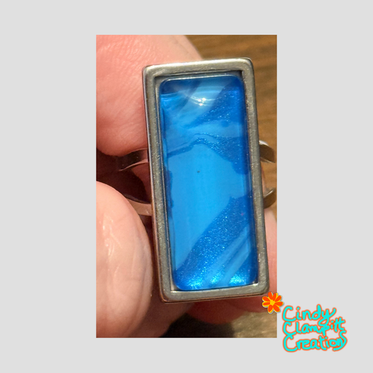 Hand-painted ocean blue glass cabochon ring on a stainless steel open-back band by Cindy Clampitt Creations
