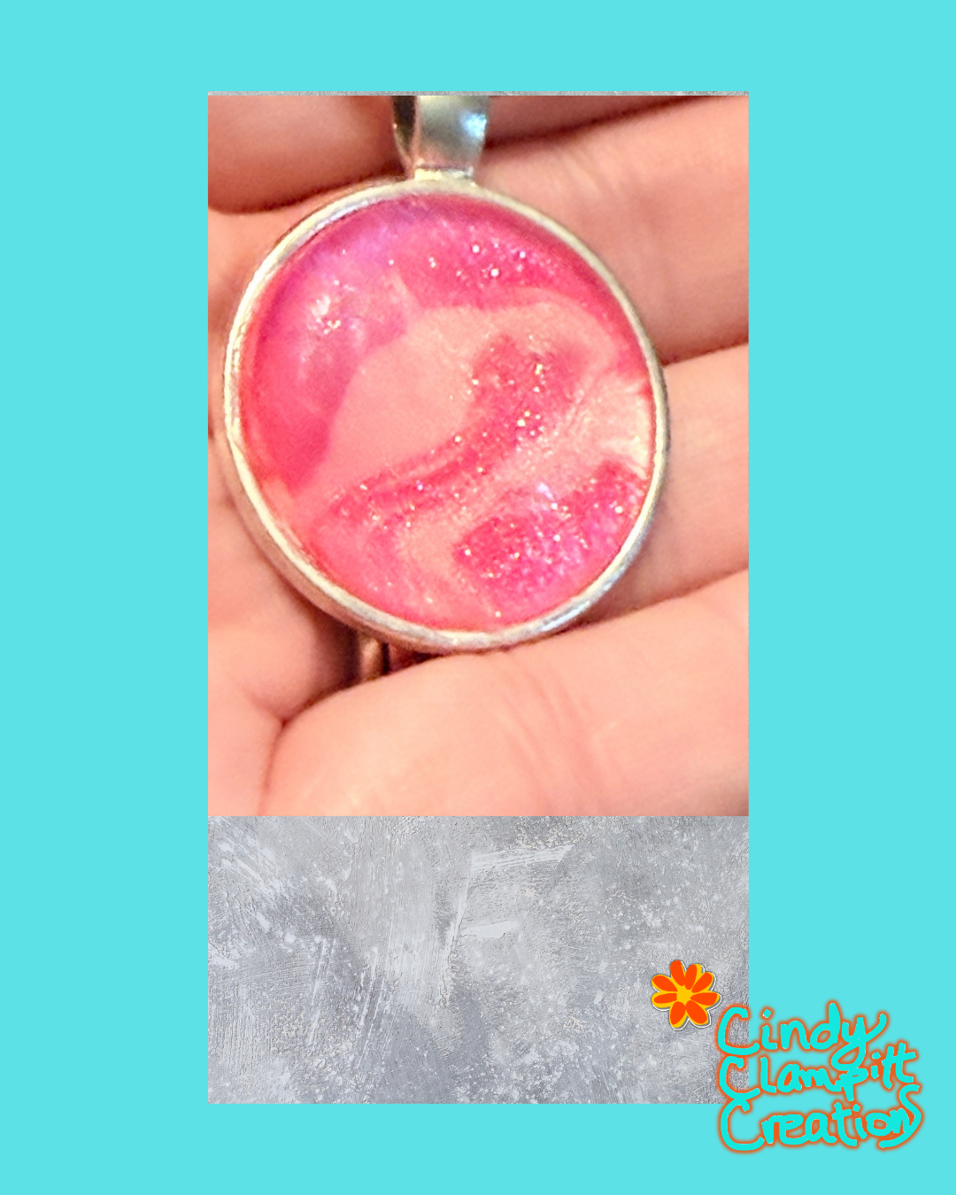 A handmade pink and white glitter pendant in a silver bezel setting, held in a person's hand, with a textured gray overlay at the bottom and a 'Cindy's Creative' logo watermark.