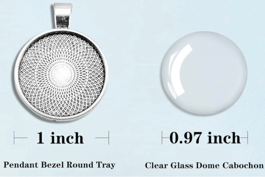 A product information graphic showing a round silver pendant bezel tray and a clear glass cabochon dome. The silver tray has a detailed circular filigree pattern and is labeled '1 inch'.